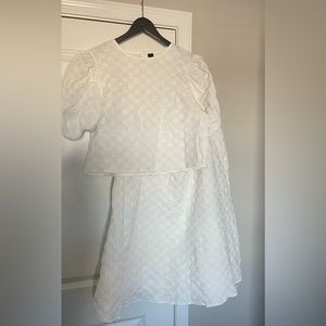 Two piece monochromatic white checkerboard skirt and top.